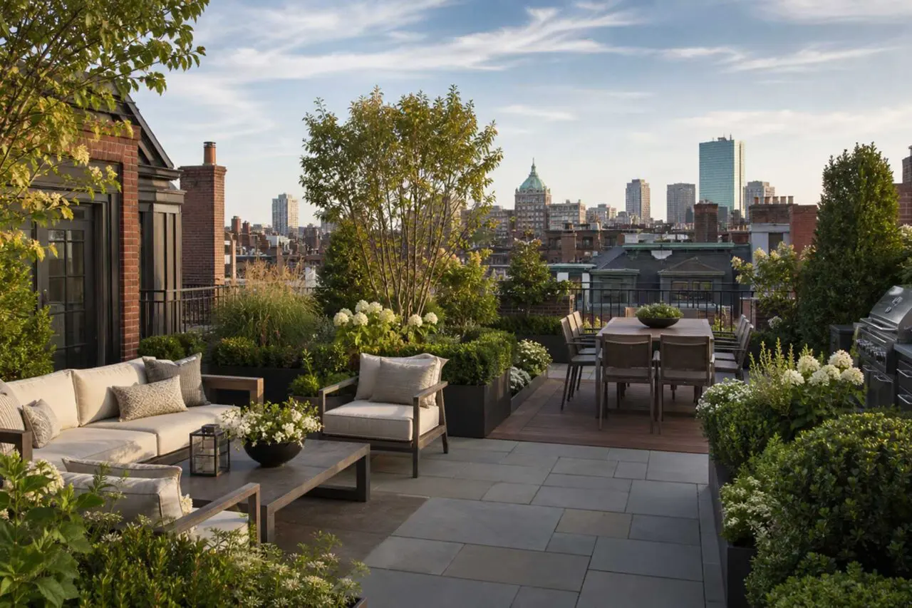 An elegant Boston rooftop terrace featuring layered gardens, comfortable lounge and dining areas, and sweeping views across the city.