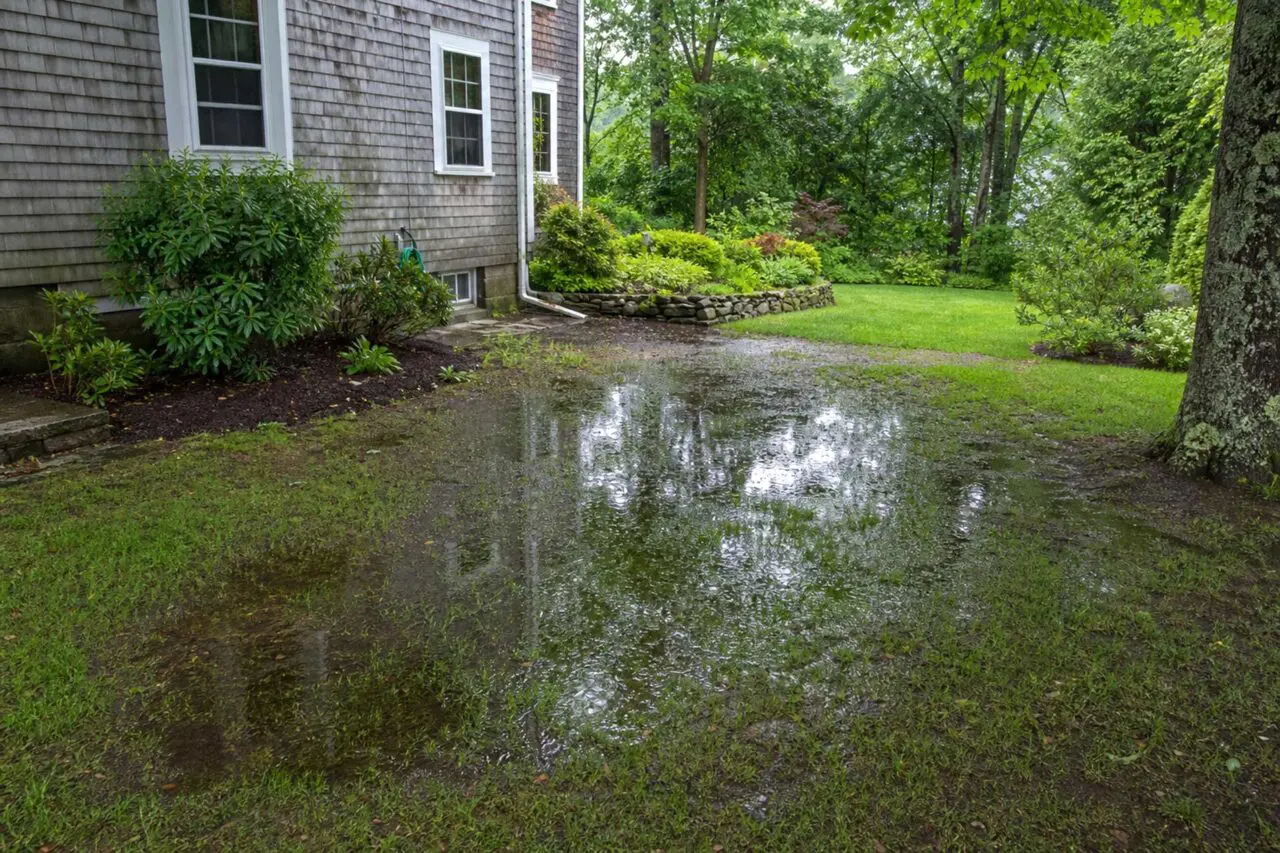 Another view shows extensive ponding and saturated lawn conditions at this Sudbury property.