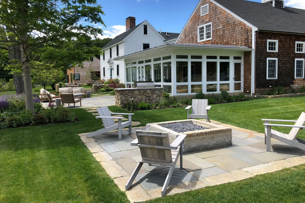 Layered stone steps guide movement through planted slopes, managing grade while adding architectural interest.