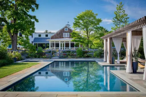 Carlisle, MA - A cedar pergola anchors the pool terrace, reinforcing agrarian character while providing shade and structure. Photo: Michael J. Lee