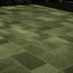 Belmont, MA - This dry-laid bluestone patio shows how frost heave, poor drainage, or an unstable base can cause individual stones to lift, sink, or rock after winter.