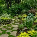 A lush woodland garden with a winding stone path, layered foliage, and shade-loving plantings, featured by Martha Stewart for its charming, naturalistic design.