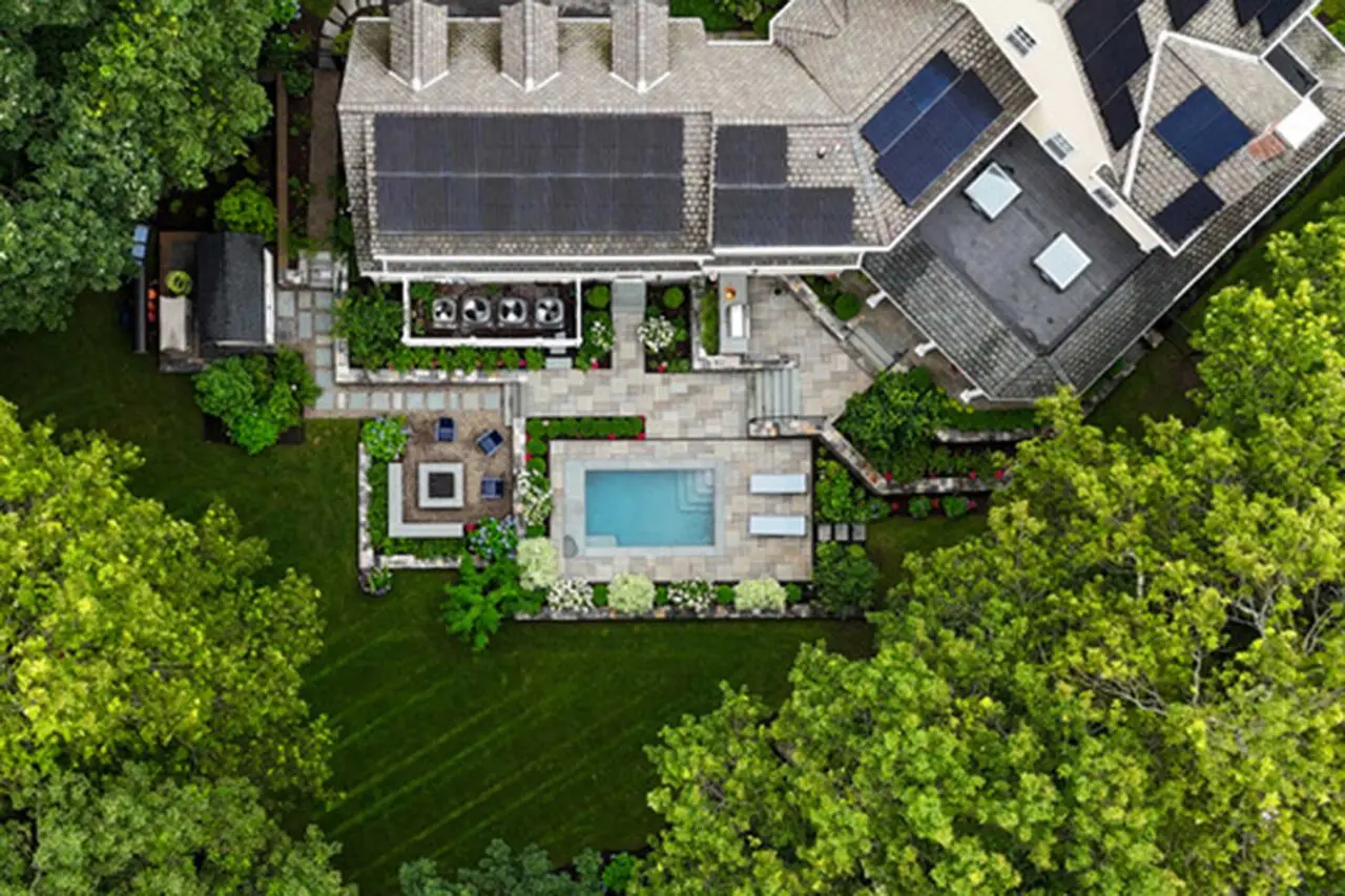 From above, the full landscape plan reveals a carefully organized composition of pool terrace, fire feature, screened porch, and connecting garden spaces.