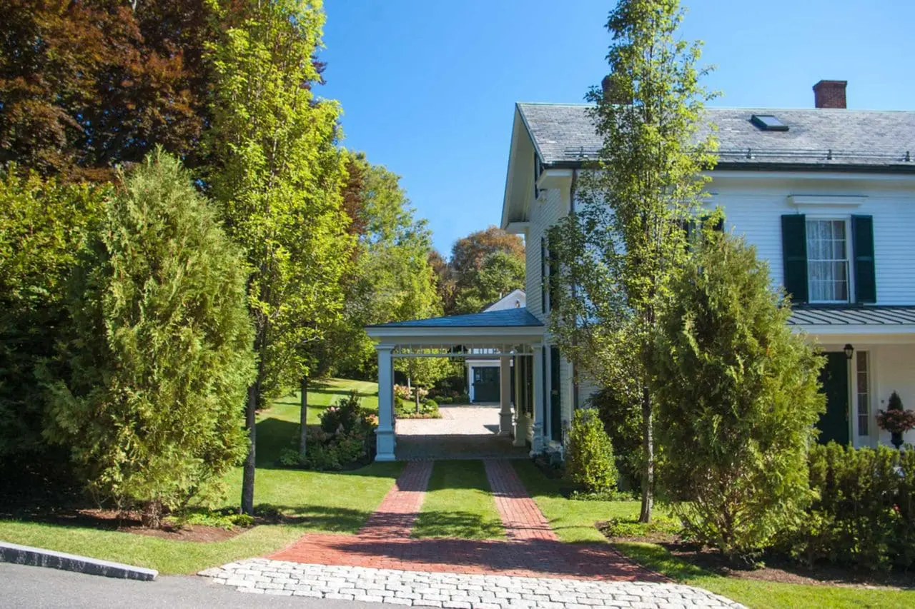 side brick drive with mature plantings