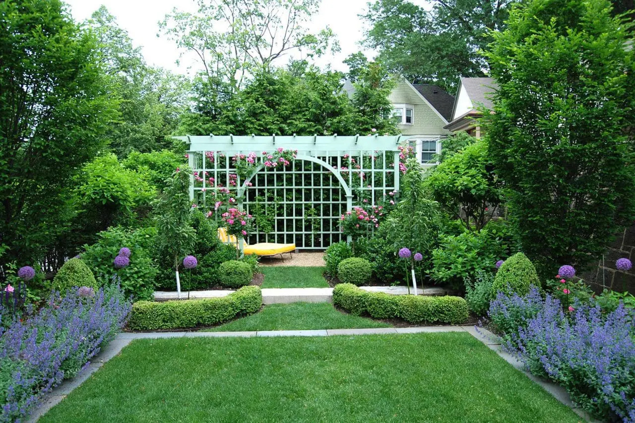 Brookline, MA - A custom trellis provides a focal point and pulls the eye along the entire garden.