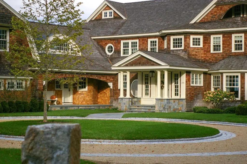 Duxbury, MA - A single London Planetree accents this spectacular circular peastone drive with granite inlay and pairs classic New England architecture with precision stonework.