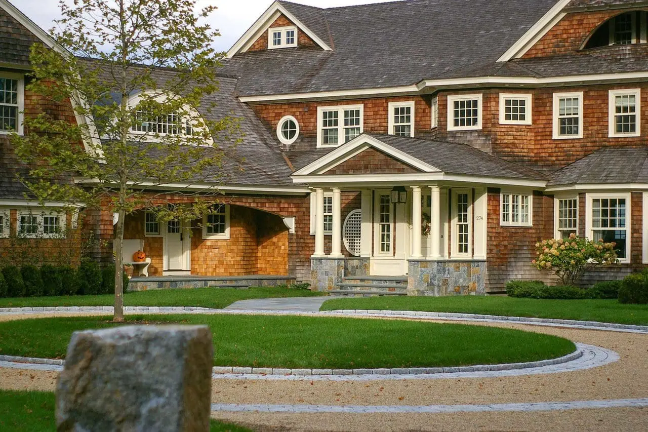 Duxbury, MA - A single London Planetree accents this spectacular circular peastone drive with granite inlay and pairs classic New England architecture with precision stonework.
