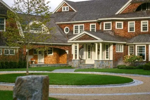 Duxbury, MA - A single London Planetree accents this spectacular circular peastone drive with granite inlay and pairs classic New England architecture with precision stonework.