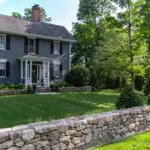 Concord, MA - A dry-laid stone wall with finished posts highlights traditional stonework and a clean roadside edge.