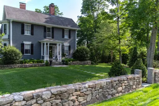 Concord, MA - A dry-laid stone wall with finished posts highlights traditional stonework and a clean roadside edge.