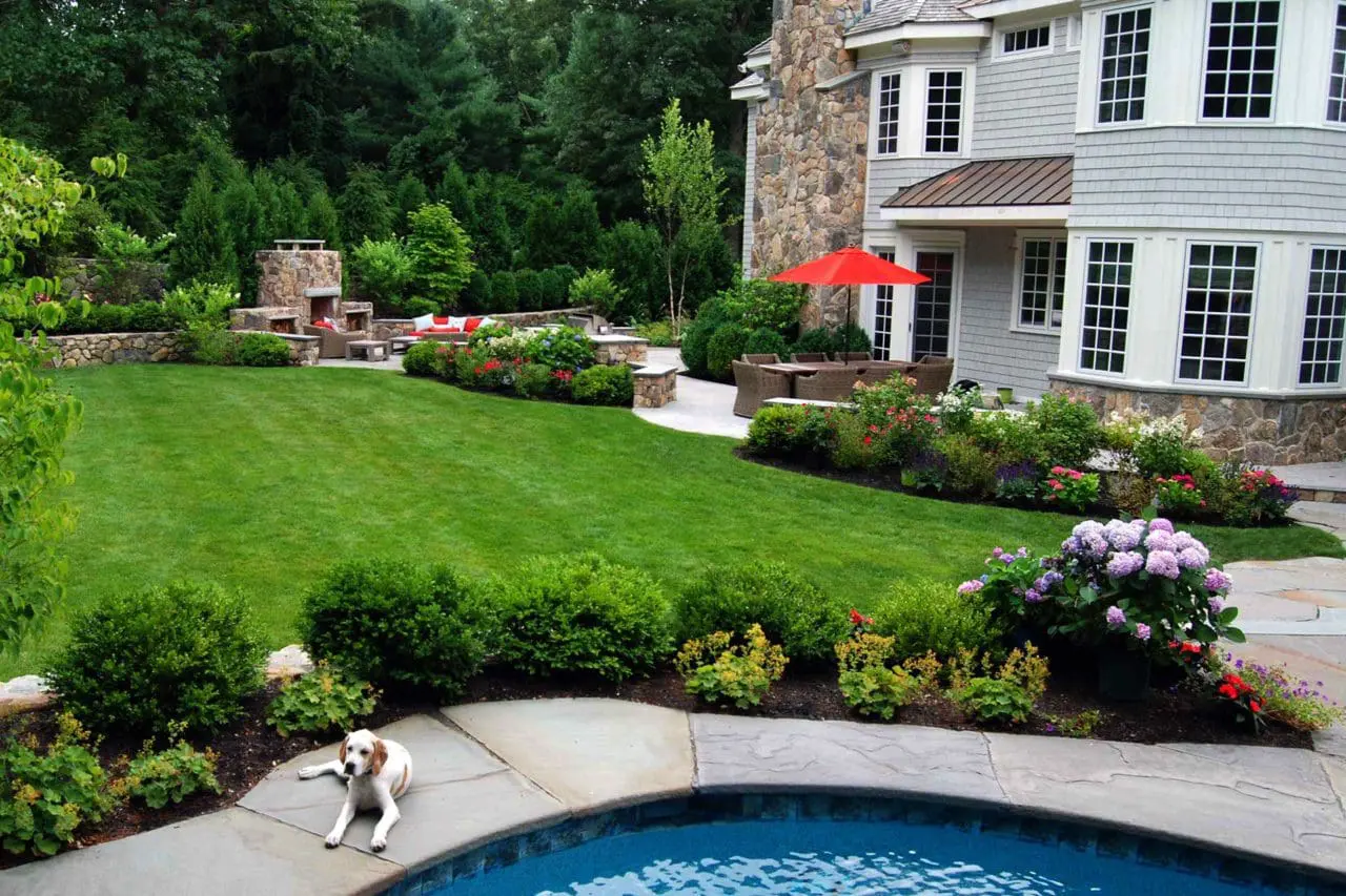 Wellesley, MA - Hedges and fieldstone walls help frame this outdoor living area.