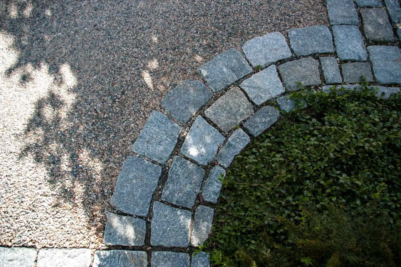 Wellesley Hills, MA - Granite block provides a classic and decorative edging material for the peastone drive.