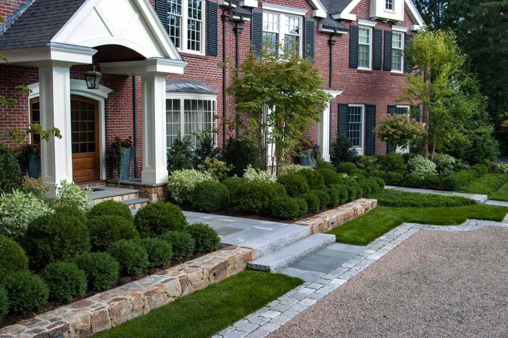 Wellesley Hills, MA - A beautiful front foundation planting including a lush mixture of boxwood and holly, Ivory Halo dogwood and hydrangea, and deciduous trees for interesting textures.