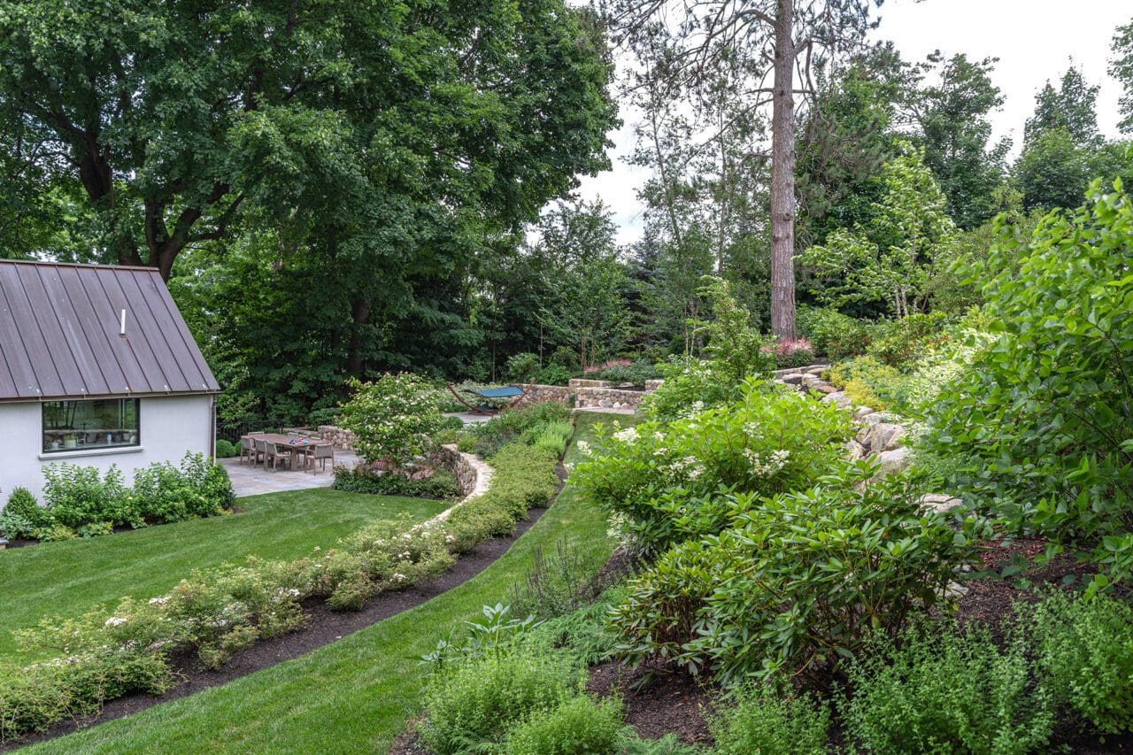 A thoughtfully layered landscape that uses mass plantings, durable materials, and simple forms to deliver strong visual impact while remaining easy to maintain over time.