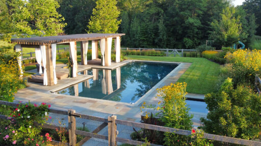Carlisle, MA - The pool terrace transitions toward open meadow plantings, balancing refined outdoor living with the surrounding rural landscape. Photo: Michael J. Lee