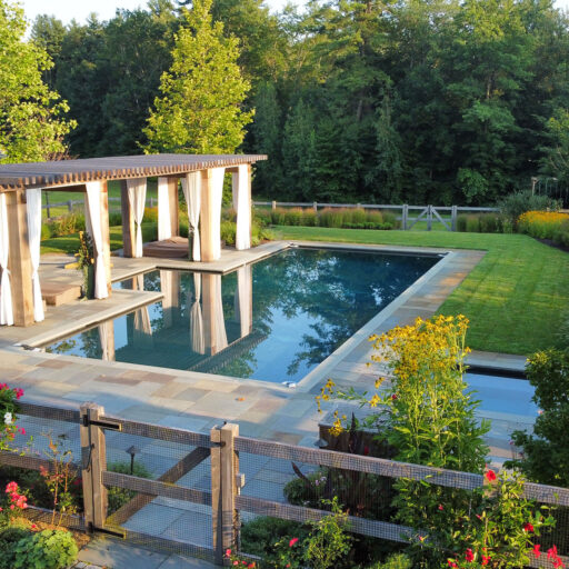 Carlisle, MA - The pool terrace transitions toward open meadow plantings, balancing refined outdoor living with the surrounding rural landscape. Photo: Michael J. Lee