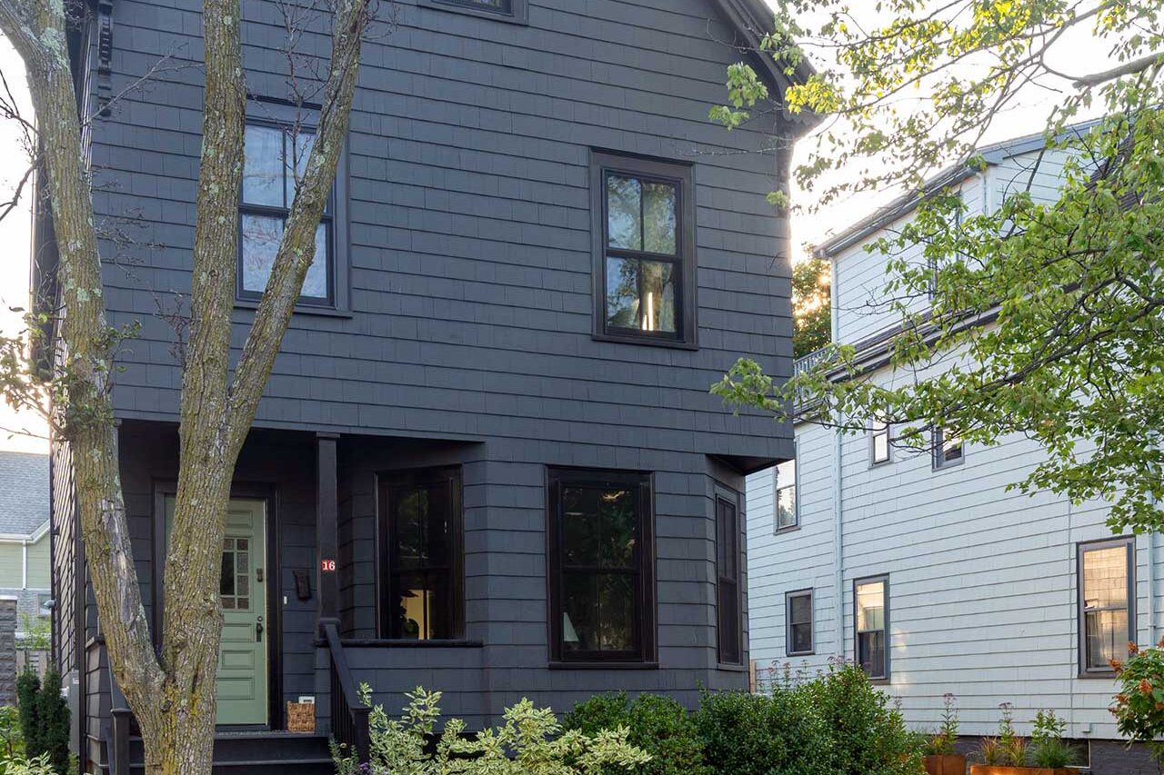 Weathering steel planters define the urban entry sequence, introducing structured planting and softening the transition between sidewalk and home.