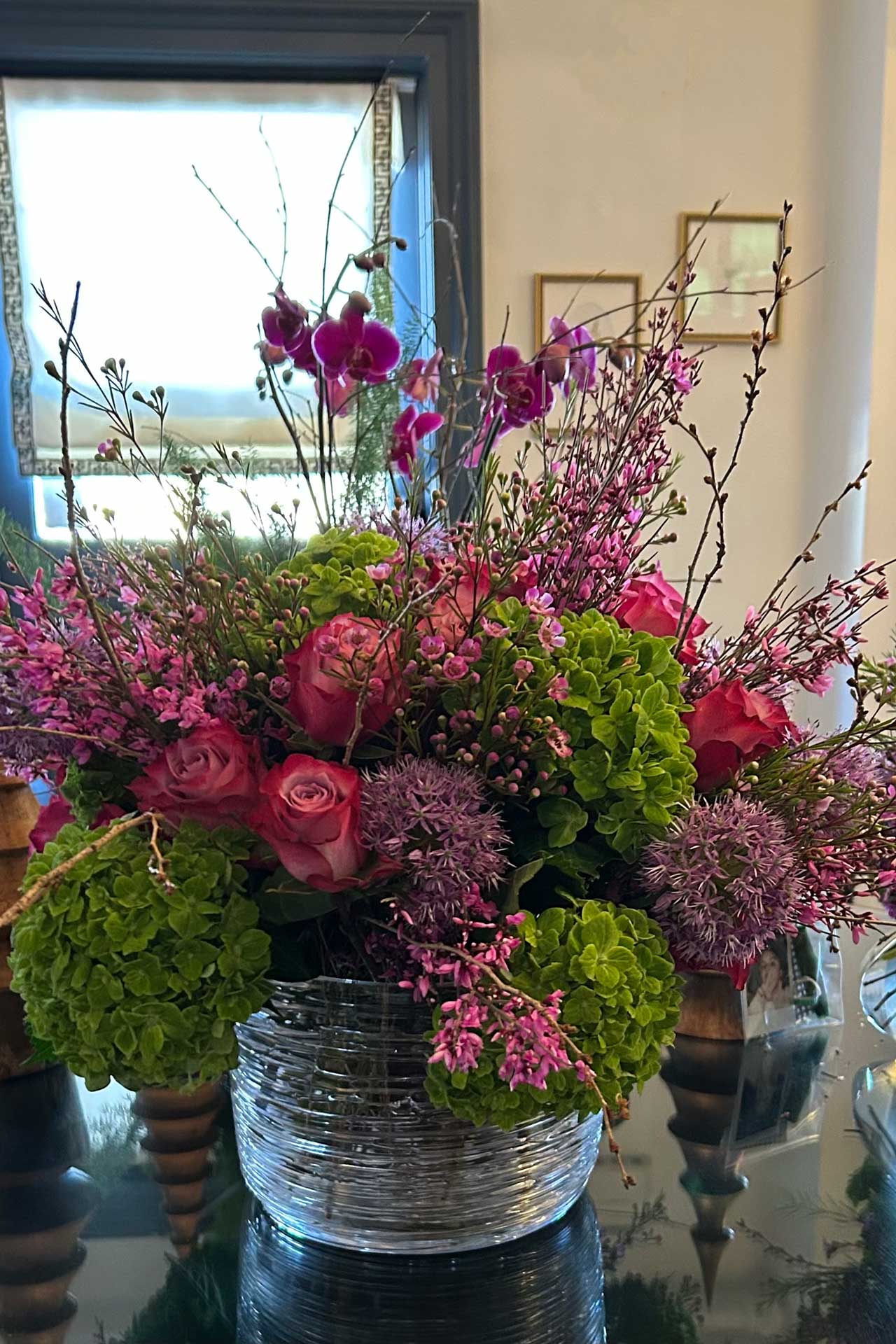 Refined arrangement of roses and orchids, installed with attention to vessel selection and maintained to extend bloom life and visual consistency.