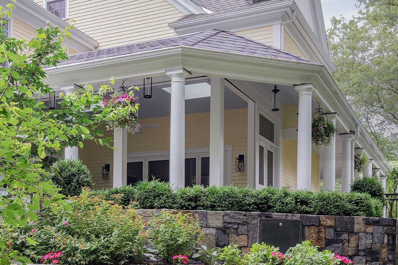 Terraced stone garden walls and layered foundation planting reinforce the home’s architecture while softening the transition into the landscape, copyright: Michael J Lee