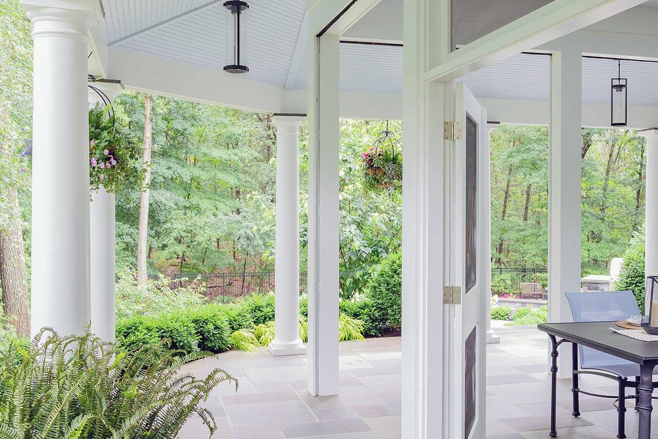 Bluestone flooring and a sheltered colonnade create a refined transition space that links the architecture to the surrounding garden and pool terrace, copyright: Michael J Lee