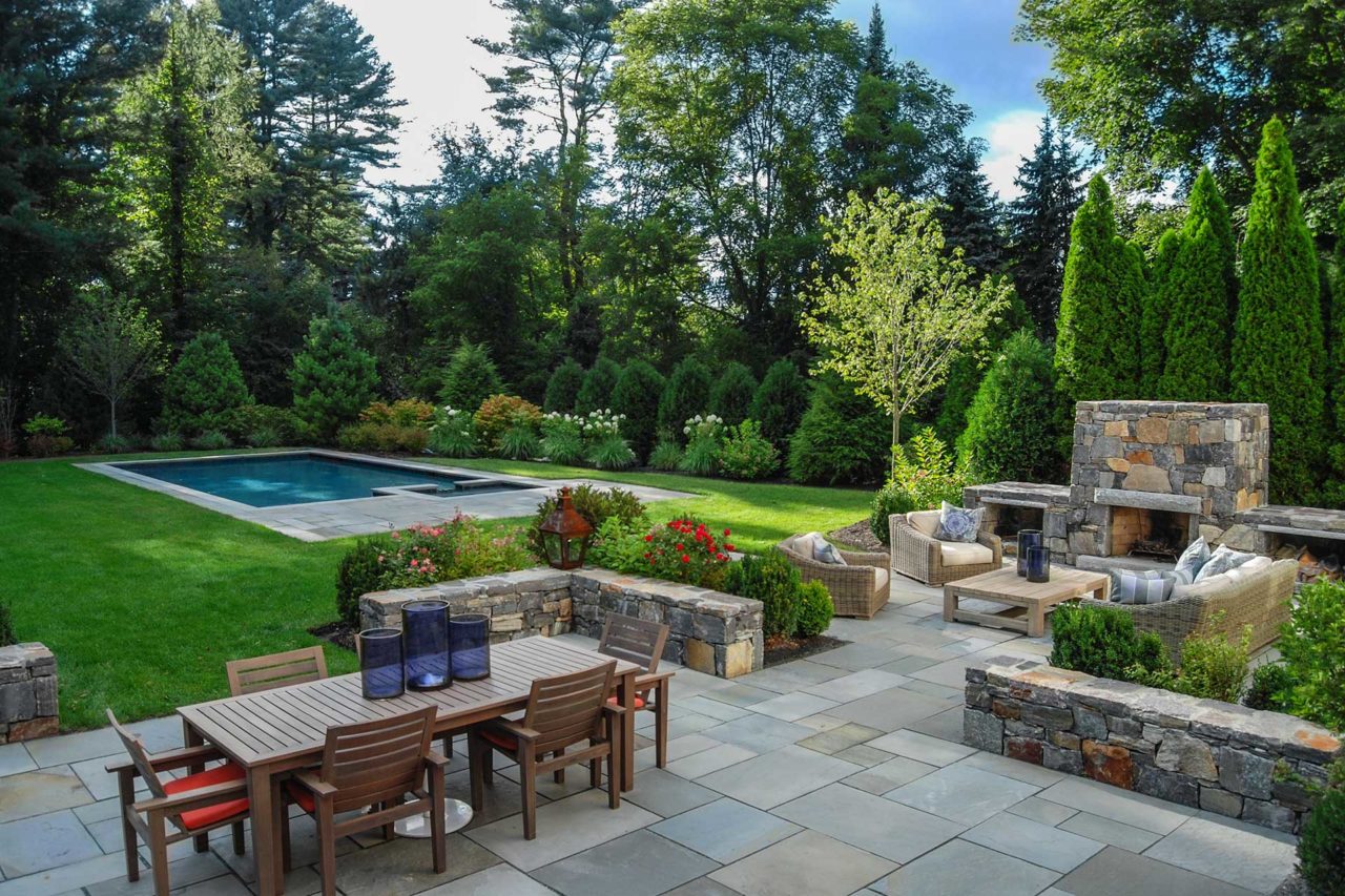 Dover, MA - Outdoor living beautifully defined: plentiful dining space, fireside gathering, and a pool and play area are ready for your weekend.