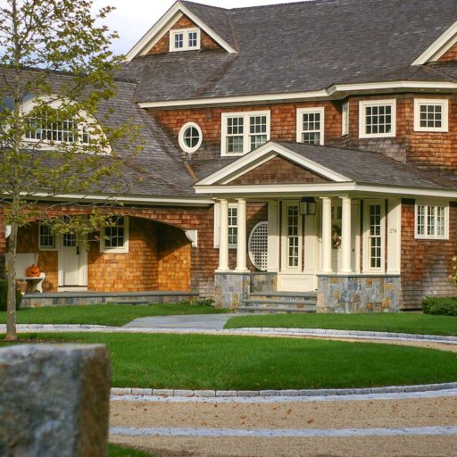 Duxbury, MA - A single London Planetree accents this spectacular circular peastone drive with granite inlay and pairs classic New England architecture with precision stonework.