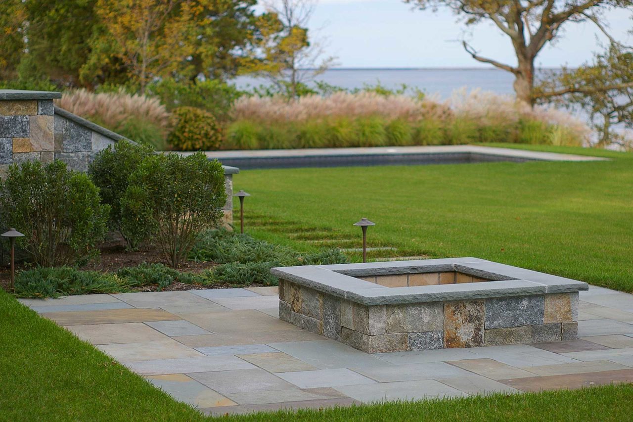 Duxbury, MA - A built in firepit area made of granite and bluestone provides an additonal spot for entertaining.