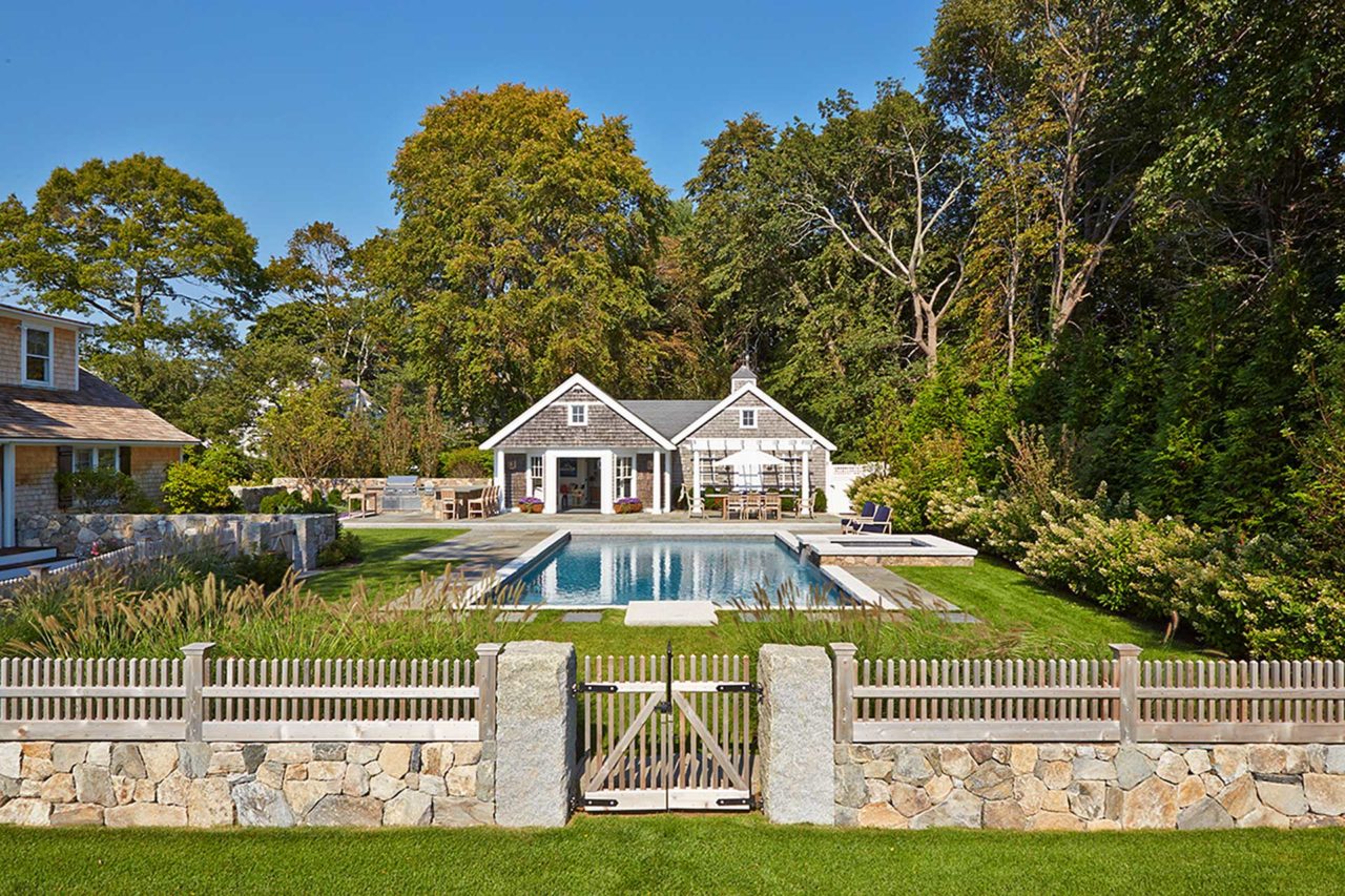 Duxbury, MA - A pool, spa, and pool house lie just beyond this finely crafted split New England fieldstone wall and fence.