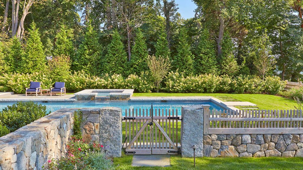 Duxbury, MA - stone masonry walls hardscaping with pool, stone fencing and gardens