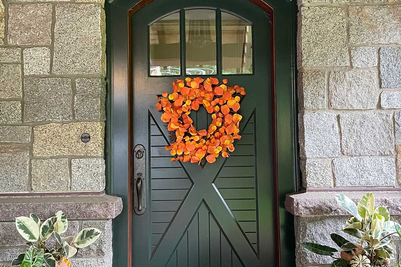 This autumn wreath introduces a warm burst of seasonal color and helps define the entry with a simple decorative statement.