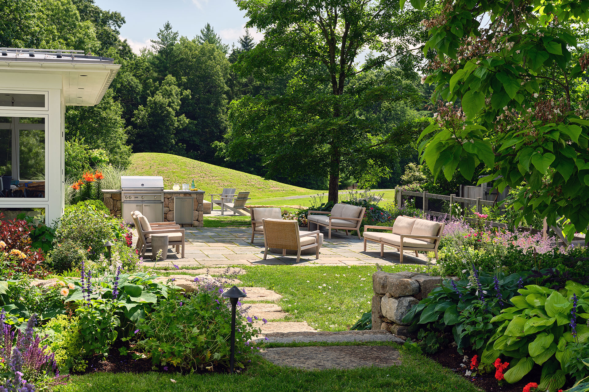 Bluestone dining terrace with sunken lounge and garden border anchors this outdoor space with rich texture, dedicated seating and memorable design.