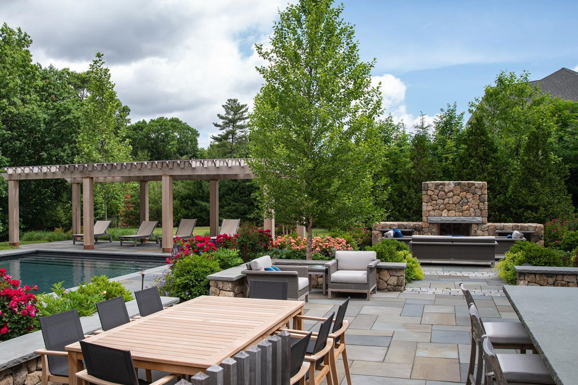 Luxury pool terrace with pergola, outdoor fireplace, and lounge zones adds resort‑style comfort and refined details for summer relaxation.
