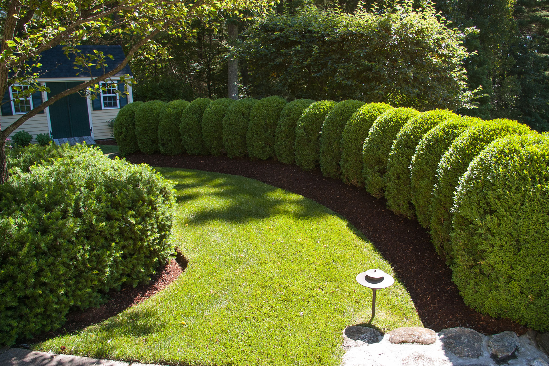 Layered hedging conceals the property from surrounding views, allowing the landscape to feel tucked away and intentional.