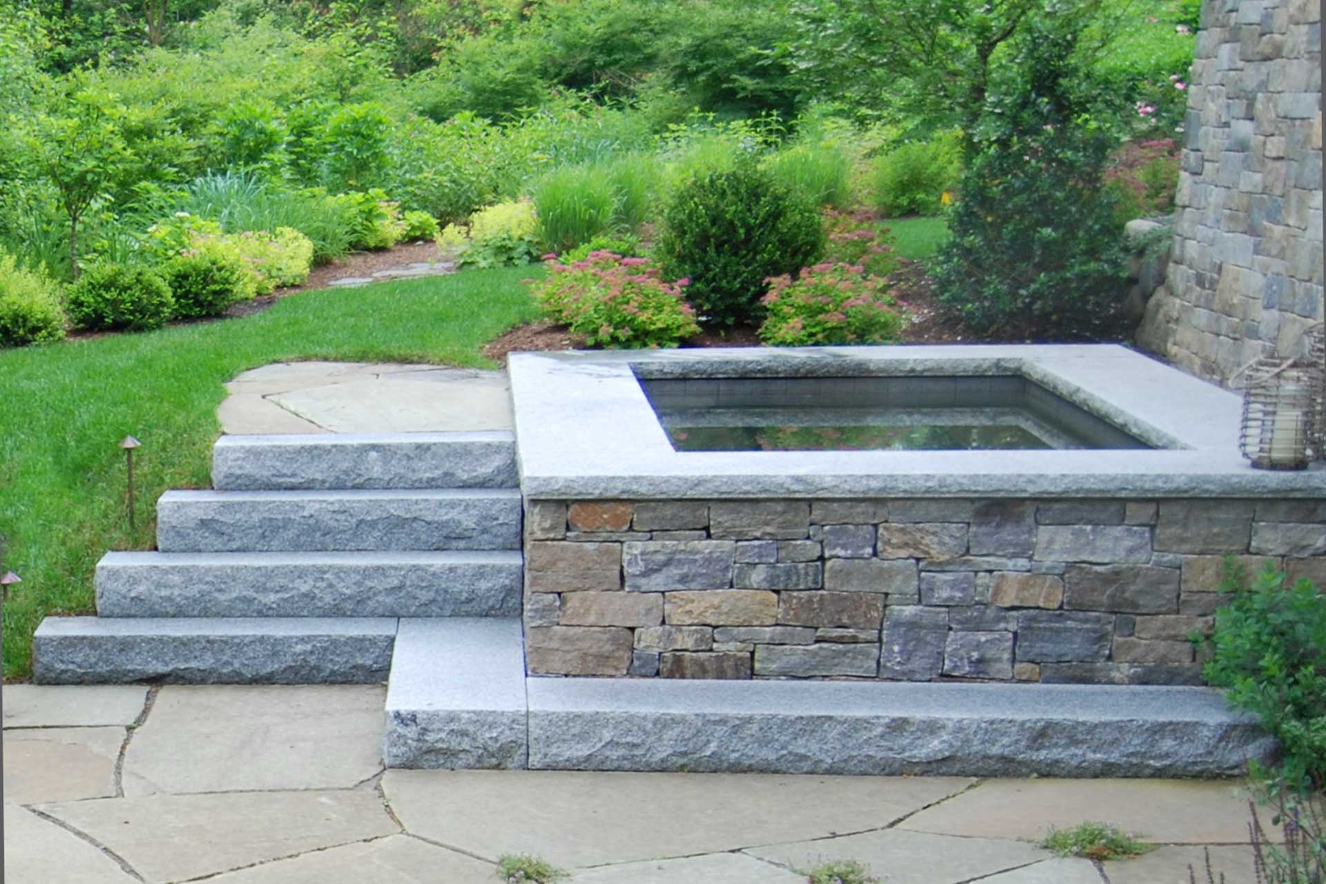 This rectangular granite basin fountain pairs clean stone detailing with subtle water movement, adding a refined focal point that enhances circulation, sound control, and visual balance within the garden.
