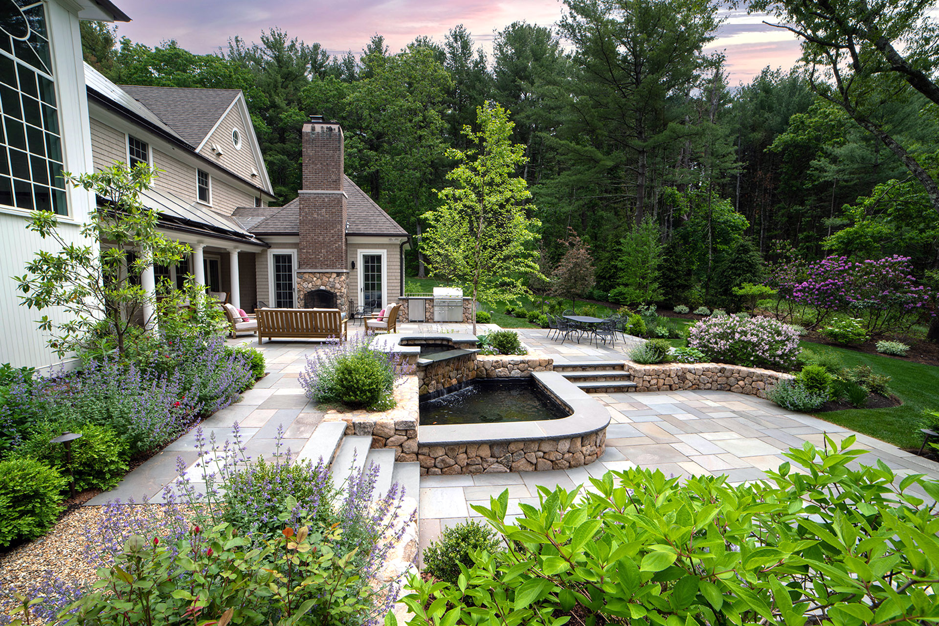 This stone waterfall blends architecture and landscape, using natural masonry to create a soothing backdrop that elevates everyday outdoor living.