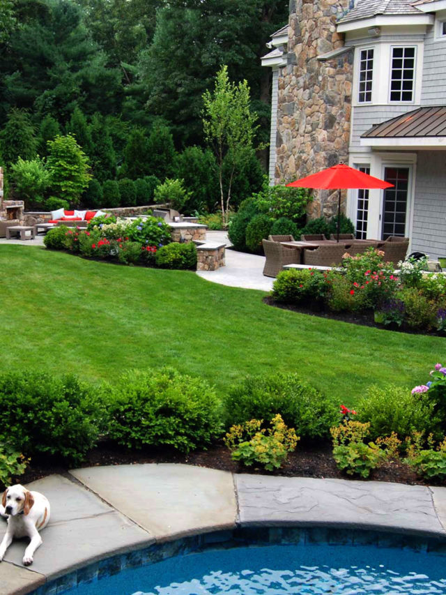 Wellesley, MA - Hedges and fieldstone walls help frame this outdoor living area.