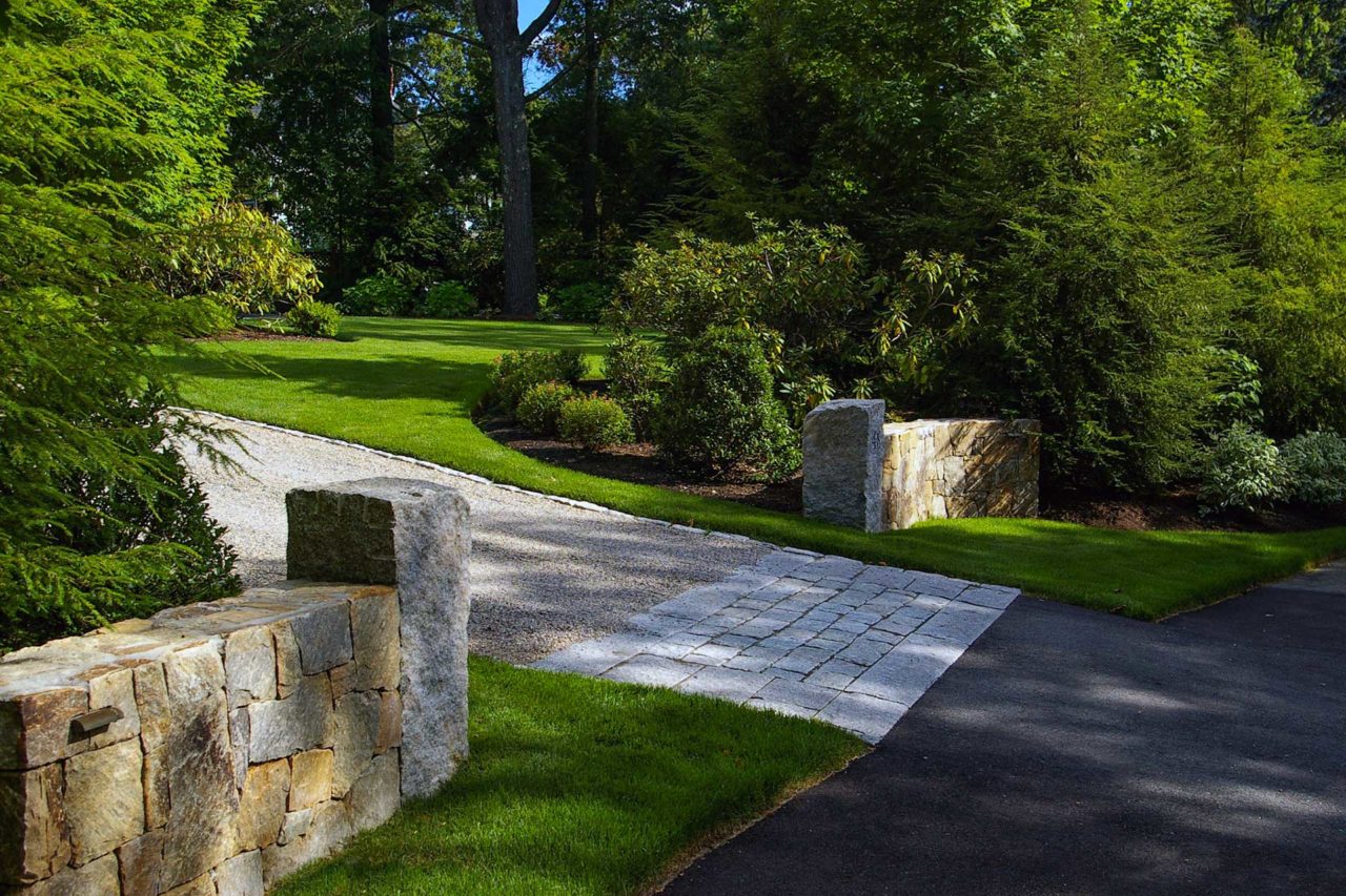 Wellesley Hills, MA - Finely crafted stone walls with reclaimed granite posts mark the entrance to the drive, while the granite apron adds a classic accent.