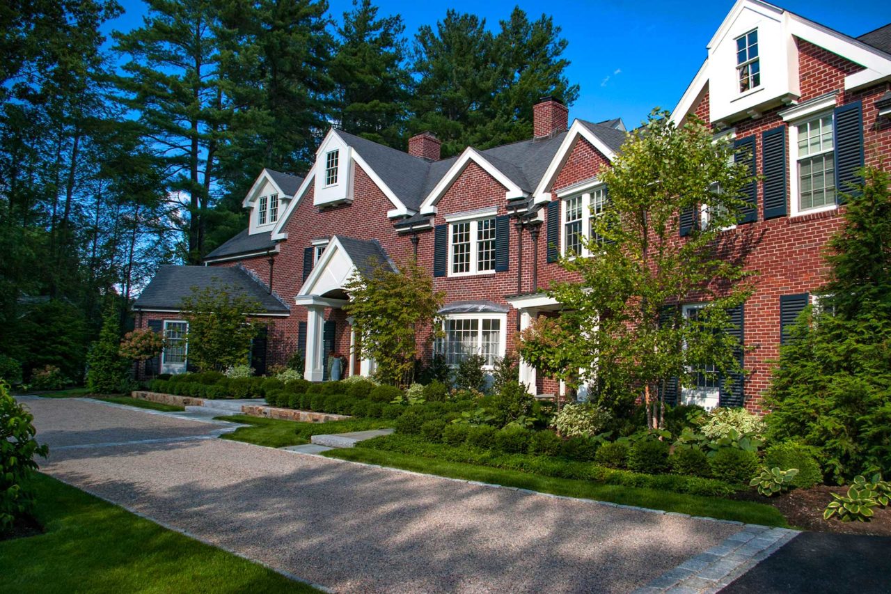 Wellesley Hills, MA – The deciduous and evergreen trees in the foundation beds help soften the brick facade and tie it together with garden beds below.