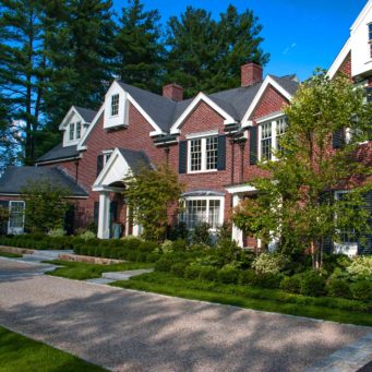 Wellesley Hills, MA – The deciduous and evergreen trees in the foundation beds help soften the brick facade and tie it together with garden beds below.