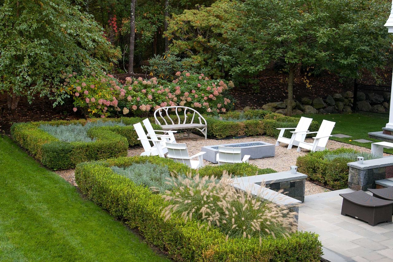 Weston, MA - Low seating walls define the patio space and the adjoining fire pit gathering area.