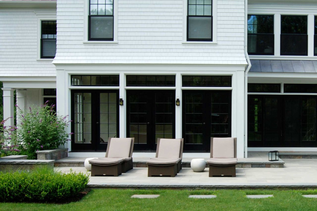 Weston, MA - back stone patio with outdoor furniture