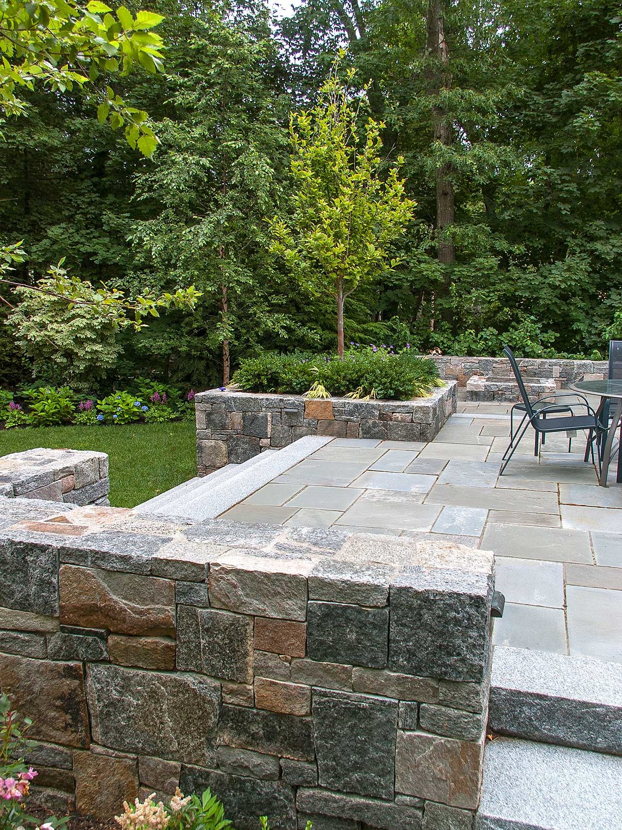 Wellesley, MA - The heavily vegetated border provides ample screening for the bluestone terraced patio.