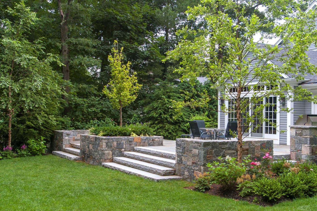 Wellesley, MA - A secluded patio framed by Corinthian granite walls. Wide granite steps lead the way to open lawn space.