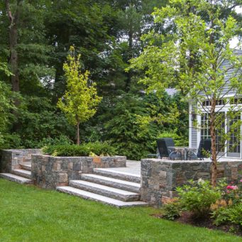 Wellesley, MA - A secluded patio framed by Corinthian granite walls. Wide granite steps lead the way to open lawn space.