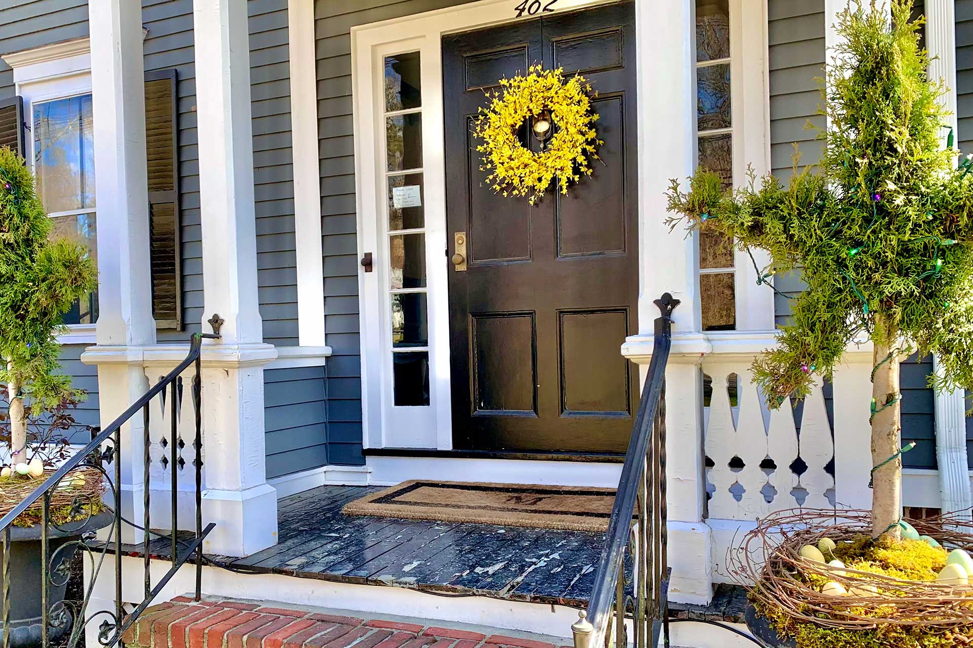 This bright yellow wreath adds a cheerful seasonal focal point and gives the front door a fresh, welcoming look.